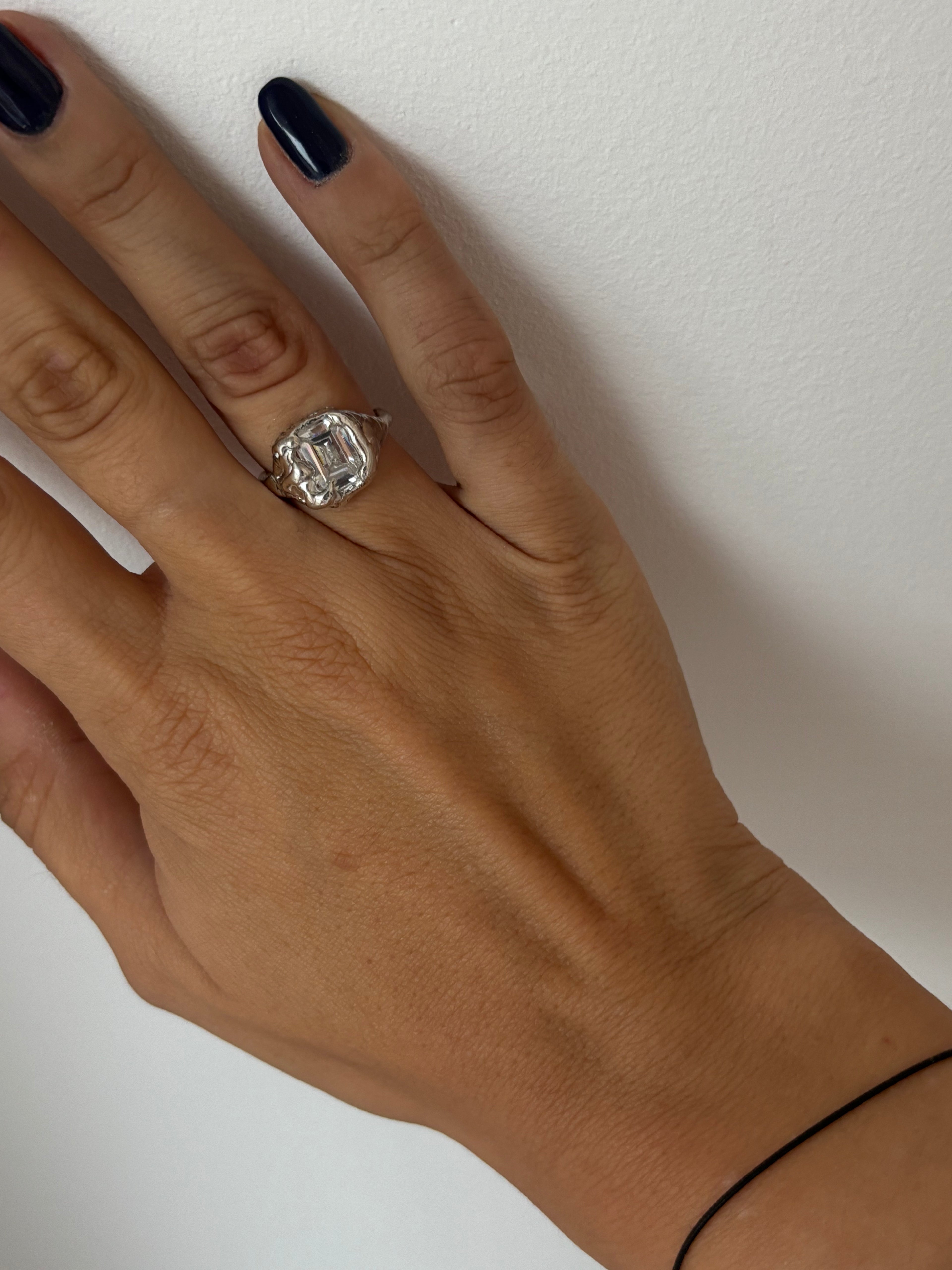 showing a sterling silver organic ring featuring a emeral cut zirconia